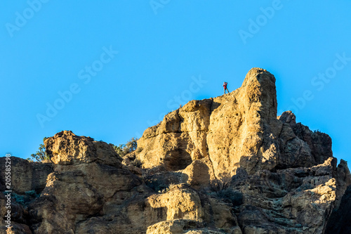 Photographer on top of rock cliff