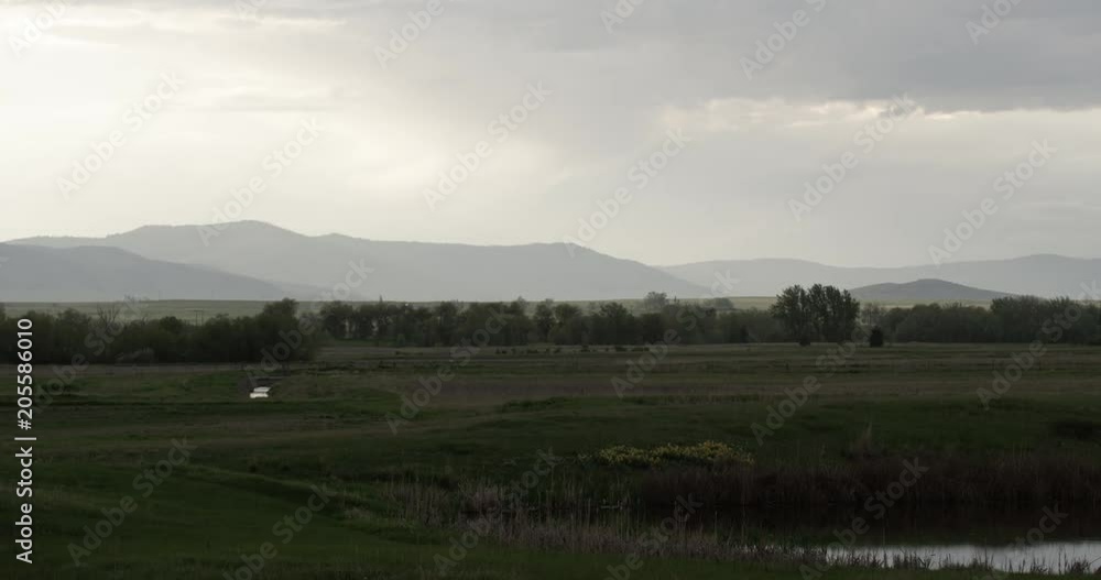 Evening rural sunset with haze over mountains and fields Evening rural sunset with haze over mountains and fields