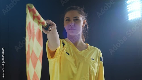Assistant female referee moving along the sideline during a soccer match