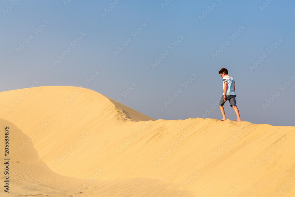 Teenage boy having fun at desert Teenage boy having fun at desert