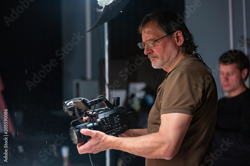camera operator working with a cinema camera photo