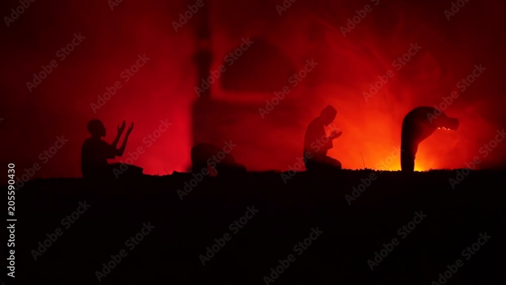 Silhouette of praying man with blurred mosque building on toned foggy background. Ramadan Kareem background. Muslim Eid holiday decoration. Praying people religion concept. Selective focus Silhouette of praying man with blurred mosque building on toned foggy background. Ramadan Kareem background. Muslim Eid holiday decoration. Praying people religion concept. Selective focus