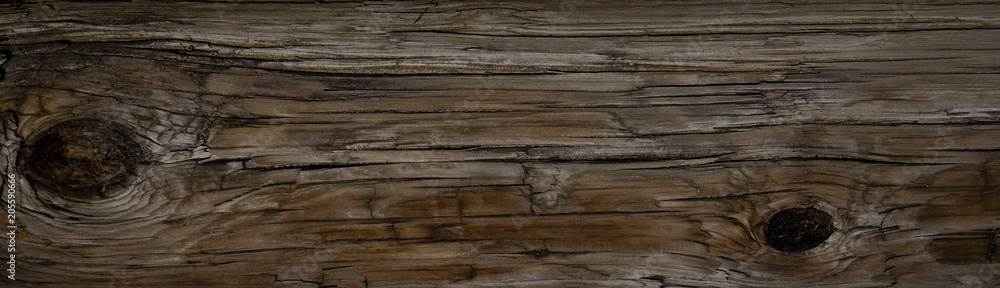 Old Dark rough wood floor or surface with splinters and knots. Square background with flooring or boards with wood grain. Old aged timber in a barn or old house. Old Dark rough wood floor or surface with splinters and knots. Square background with flooring or boards with wood grain. Old aged timber in a barn or old house.