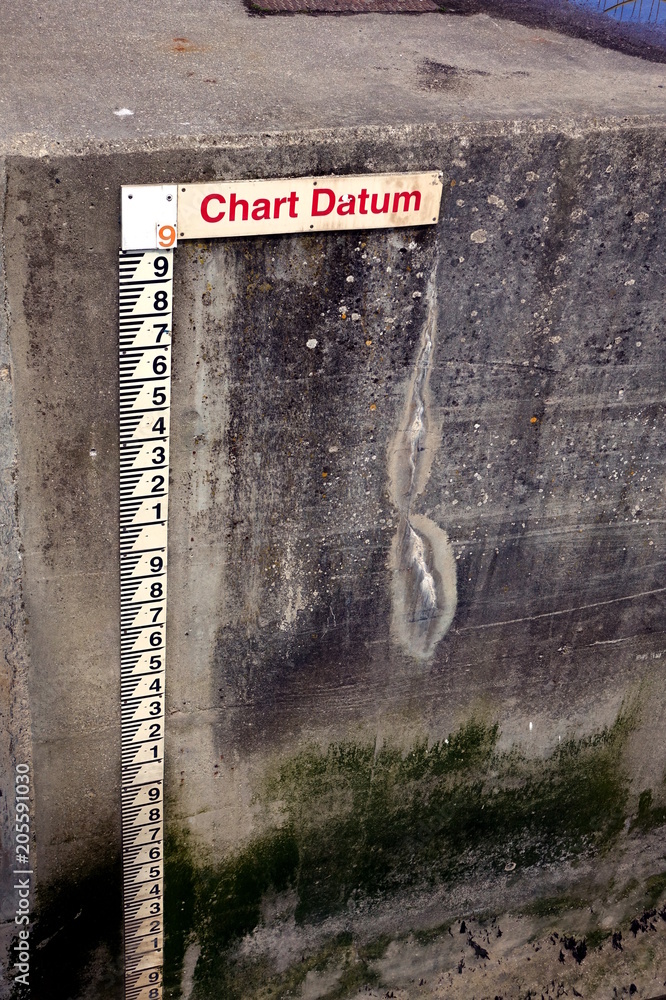 Tide gauge or tide staff on a harbour wall, showing chart datum, used Chart Datum Depth