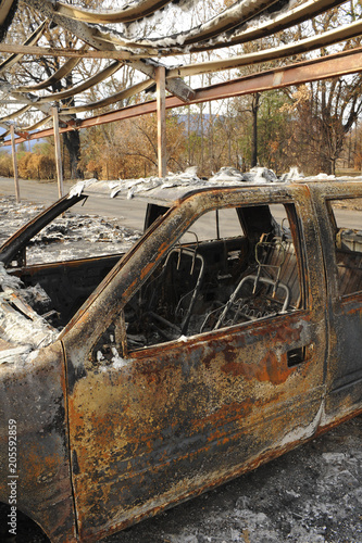 Fire damage of an SUV vehicle and parking lot.