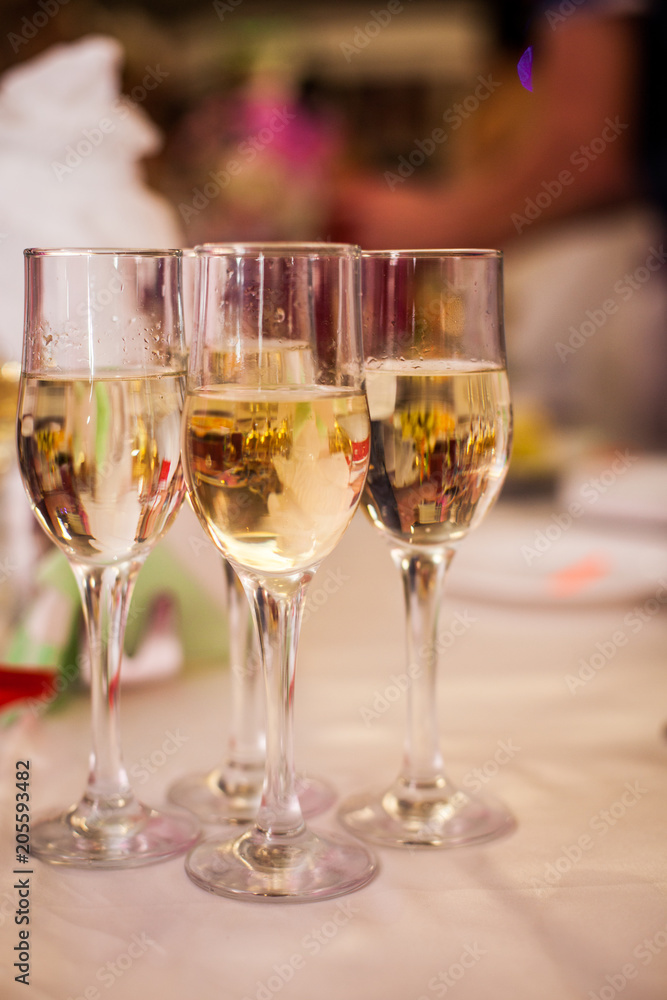 Glasses with white wine on blurred background Glasses with white wine on blurred background