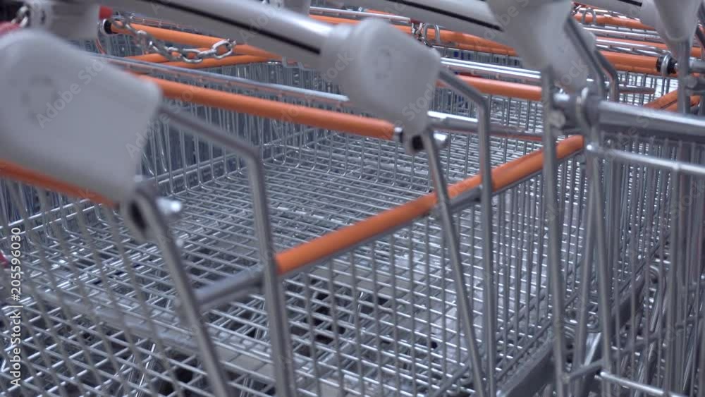 A pushcart queue on the grocery store A pushcart queue on the grocery store
