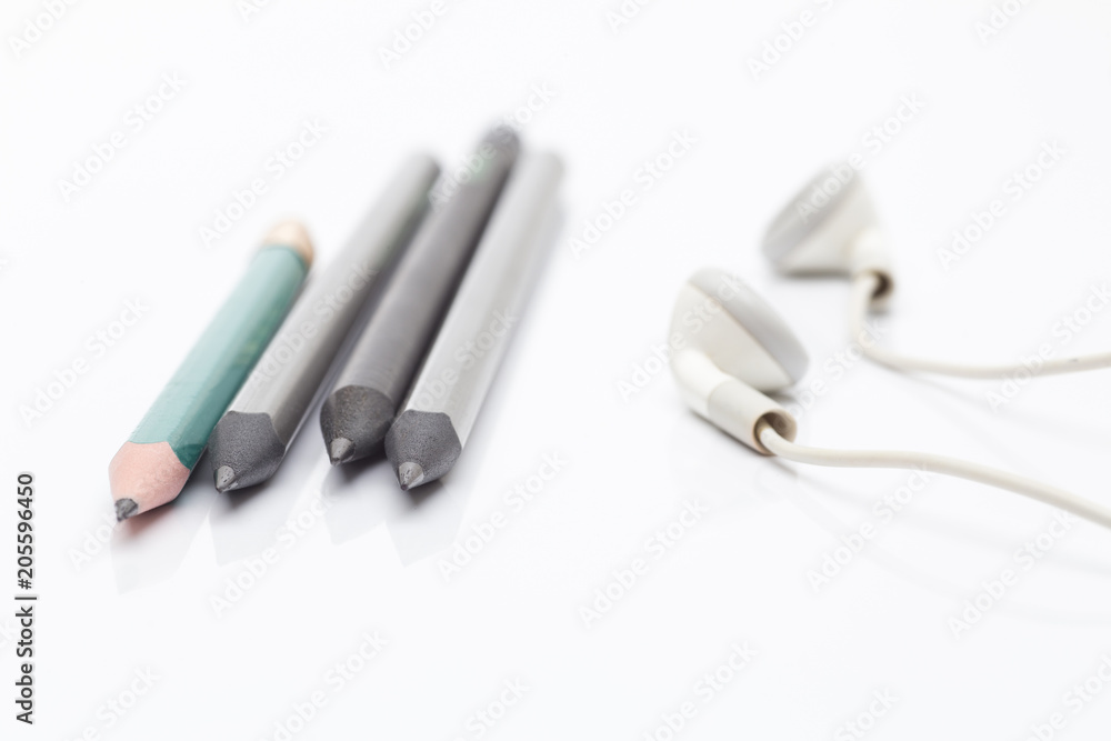 Pencils drawing and a white headphone on a white background Pencils drawing and a white headphone on a white background