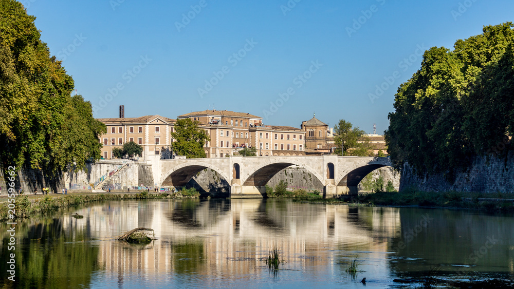 Bridges reflecting in a still River Tiber, Rome, Italy