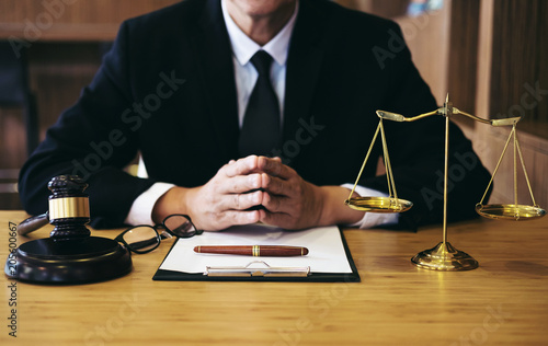 Judge gavel with Justice lawyers, Businessman in suit or lawyer working on a documents. Legal law, advice and justice concept photo