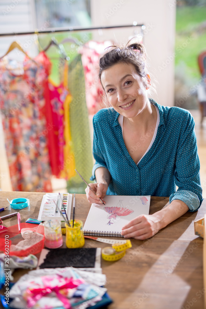 Fototapeta premium Fashion designer working on a new model, in her studio