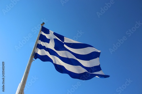 Flag of Greece with the cloudless blue sky in the background