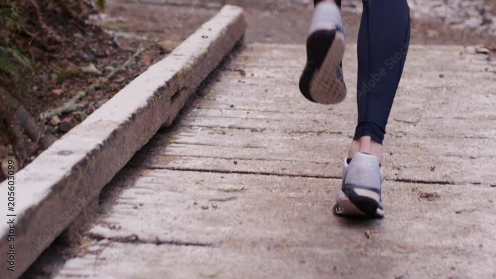 Slow Motion Trail Running - Woman runs over bridge Slow Motion Trail Running - Woman runs over bridge