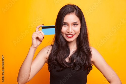Young Asian woman point to a blank card.