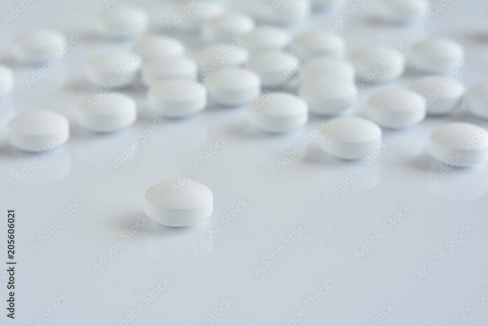 White pills on a white background
White pills on a white background