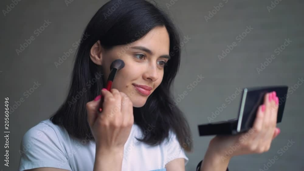 Beauty teenage girl applying mascara make-up and admiring herself in the mirror. Beautiful student girl looking in the mirror at home and apply make up. Beauty teenage girl applying mascara make-up and admiring herself in the mirror. Beautiful student girl looking in the mirror at home and apply make up.