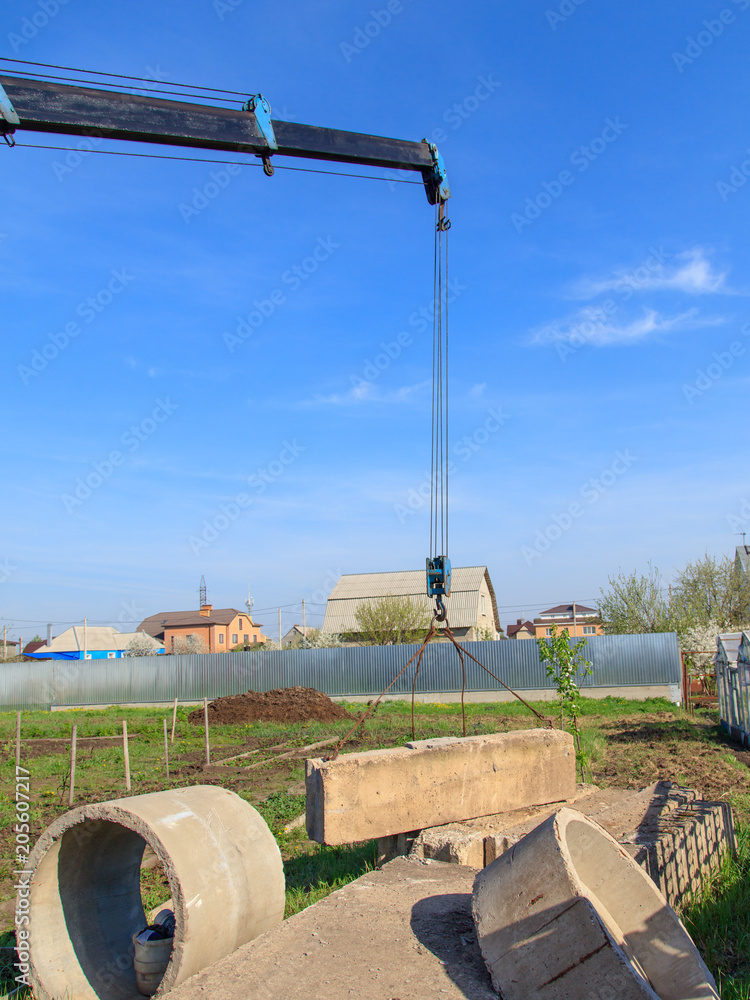 The crane loads old concrete blocks at the construction site The crane loads old concrete blocks at the construction site