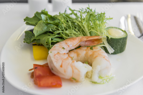 Set inflight meal shrimp on a tray, on a white table