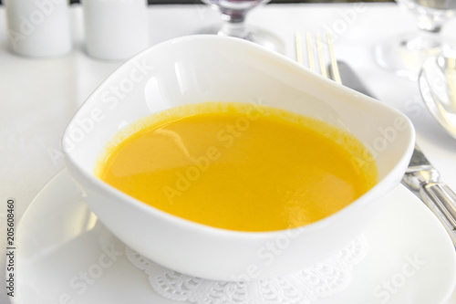 Set inflight meal soup on a tray, on a white table