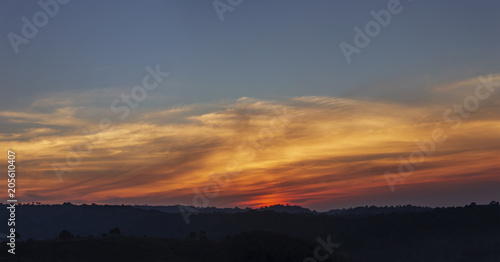 Panorama view of orange sunrise and cloud over silhouette mountain © mathisa