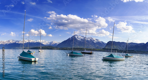 Sailing boats in port at lake Thun infornt of Alps mountain in the evening