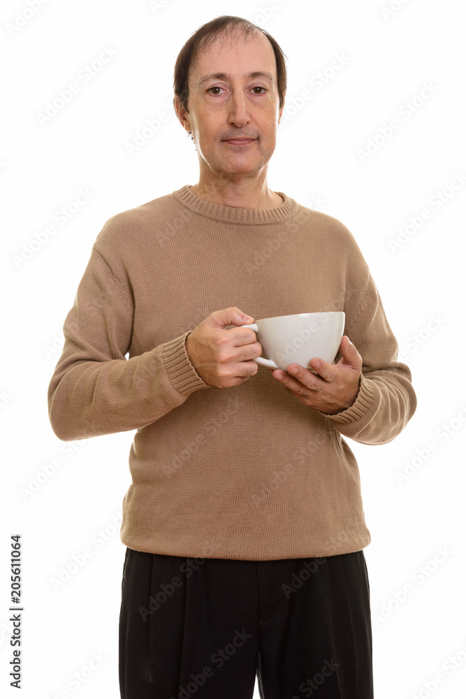 Studio shot of mature man holding coffee cup Studio shot of mature man holding coffee cup