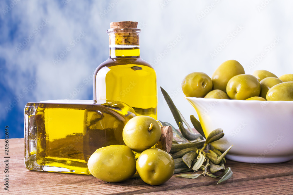 bowl of olives and bottle of extra virgin oil on background bowl of olives and bottle of extra virgin oil on background