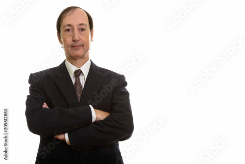 Studio shot of mature businessman with arms crossed