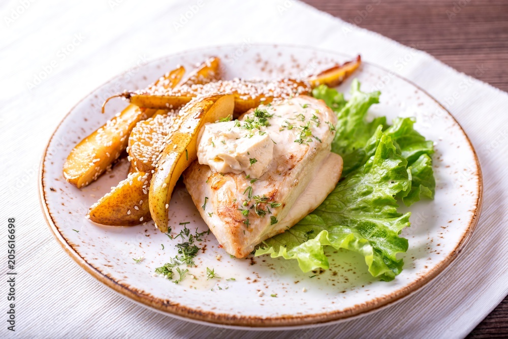 Fried chicken fillet with a pear and sauce of Dorblu