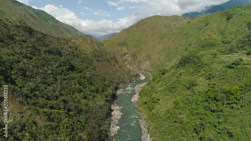 Aerial view of mountain river in the cordillera gorge, mountains covered forest, trees. Cordillera region. Luzon, Philippines. Mountain landscape.