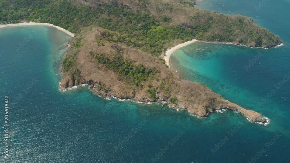 Aerial view of seashore with beach, lagoons and coral reefs. Philippines, Luzon. Coast ocean with tropical beach, turquoise water. Tropical landscape in Asia.