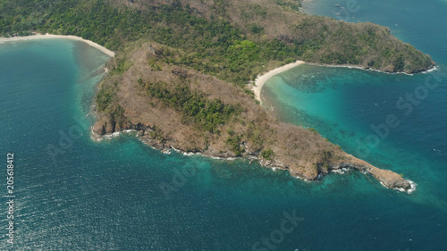 Aerial view of seashore with beach, lagoons and coral reefs. Philippines, Luzon. Coast ocean with tropical beach, turquoise water. Tropical landscape in Asia.