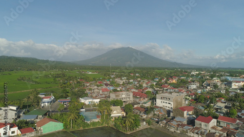 Aerial view of town in a mountain valley at the foot of the mountain Iriga. Luzon, Philippines. Mountainous tropical landscape. © Alex Traveler