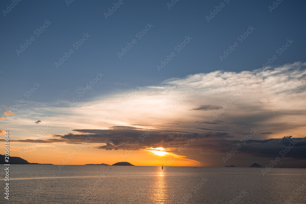 Sea sunset with beautiful clouds and mountains on the gorizon.