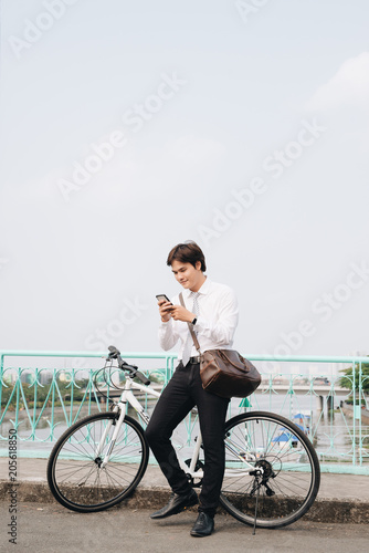 Fototapeta Naklejka Na Ścianę i Meble -  young urban fashion with bike and mobile phone