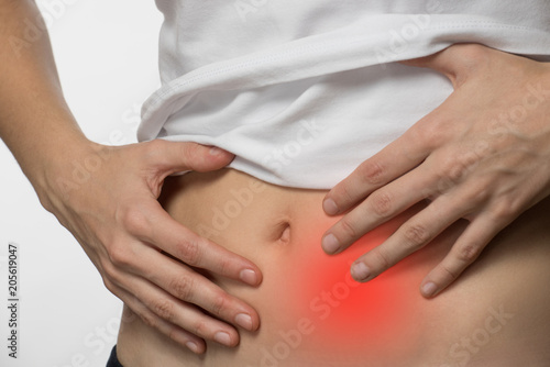 Wallpaper Mural Pain and cramps in the abdomen of a beautiful girl on a white background Torontodigital.ca