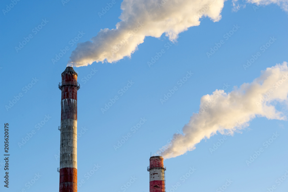 industrial smoke from chimney on blue sky