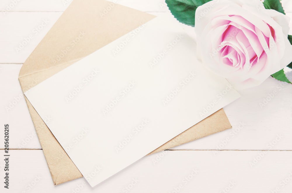Blank white greeting card with brown envelope and purple rose Blank white greeting card with brown envelope and purple rose