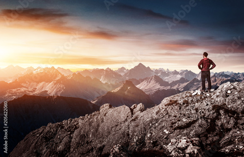 Silhouette of man standing on rock in mountains © XtravaganT