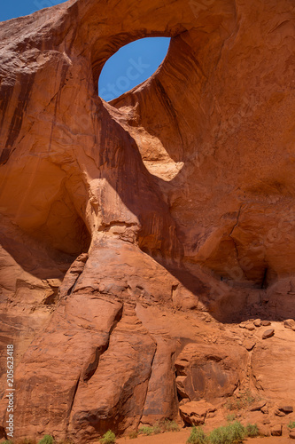 Eye of the eagle Big Hogan. Pothole natural arch eroded in sandstone.