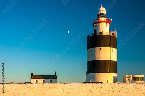 Hook Head lighthouse at sunset, county Wexford, Ireland photo