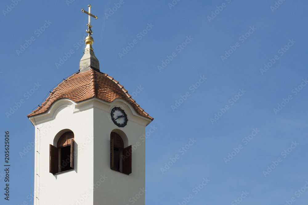 Church tower with the windows, with clocks and with negative space for text Church tower with the windows, with clocks and with negative space for text