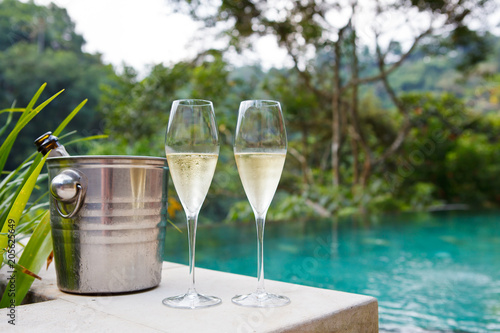 glasses of champagne near tropic pool