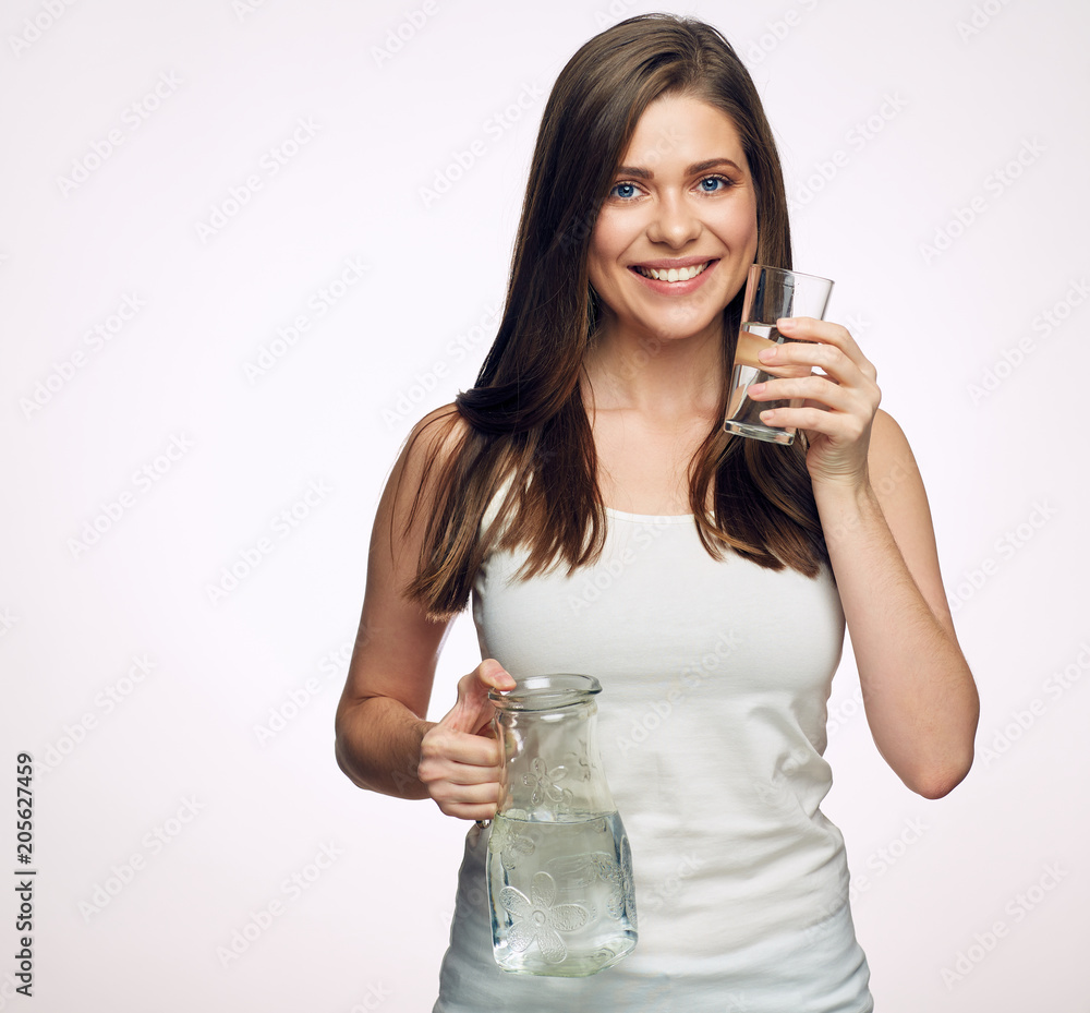 Woman drinking water holding glass dekanter. Woman drinking water holding glass dekanter.