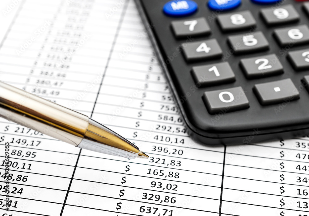 Pen pointing on numbers on financial document. Pen pointing on numbers on financial document.