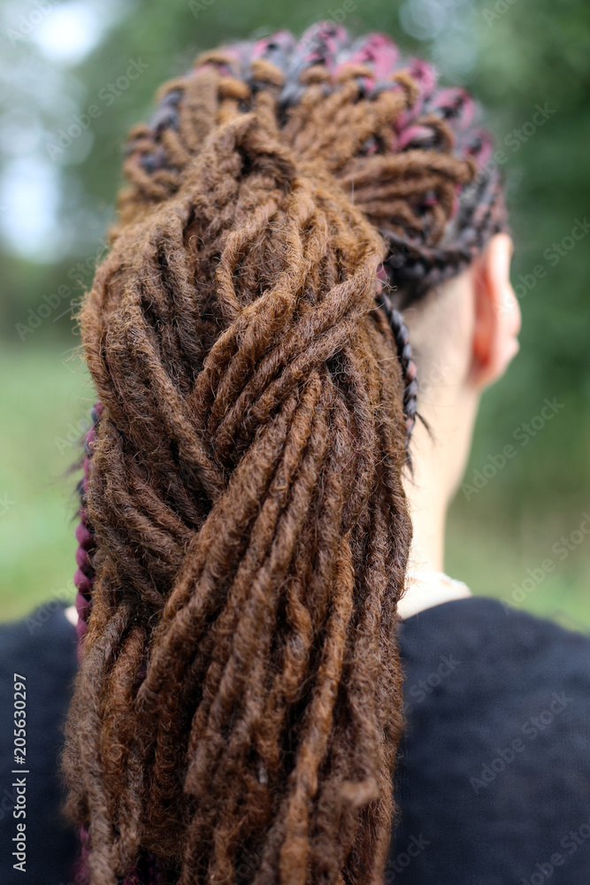man with dreadlocks on a neutral background, subculture, street style, youth hairstyles