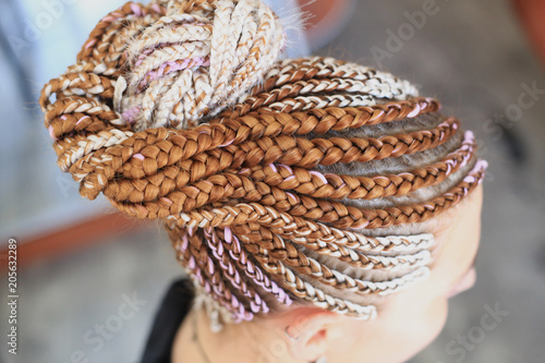 african hairstyle brady in tail with kanekalon on girl's head close-up, hair texture photo