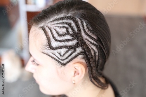 pigtails with a picture on the temple of a girl, braided with the effect of a shaven temple, the texture of a close-up, hair, a hairstyle on the head of a girl © Сабина Аблизина