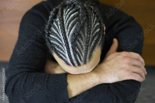 small braids on his head Man with face covered, dark hair, Schoten