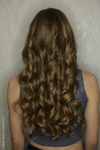 texture of hair, curls on the head of a girl on a white background close-up of beauty salons, curling